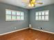 Inviting bedroom featuring plantation shutters and hardwood floors at 2523 Krueger Lane, Tampa, FL 33618