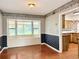 Dining room features hardwood floors, bay window with bench seating, and decorative wallpaper at 2523 Krueger Lane, Tampa, FL 33618
