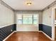 Dining room with hardwood floors, bay window with bench seating, and decorative wallpaper at 2523 Krueger Lane, Tampa, FL 33618