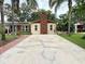 Attractive home with long concrete driveway, brick chimney, colorful landscaping, and mature palm trees at 2523 Krueger Lane, Tampa, FL 33618