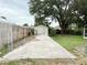 Long, cement driveway runs up to shed surrounded by lush landscaping at 2523 Krueger Lane, Tampa, FL 33618
