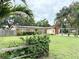 Beautiful Florida ranch-style home with solar panels, large landscaped yard and mature palm trees at 2523 Krueger Lane, Tampa, FL 33618