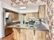 Cozy kitchen features wood cabinets, tiled countertops, and stainless steel refrigerator at 2523 Krueger Lane, Tampa, FL 33618
