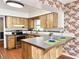 Kitchen with wood cabinets, tile countertops and stainless appliances at 2523 Krueger Lane, Tampa, FL 33618