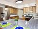 Bright kitchen featuring wood cabinets, tiled countertops, and stainless steel refrigerator at 2523 Krueger Lane, Tampa, FL 33618