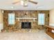 Cozy living room with stone fireplace, white mantel, and tiled floor at 2523 Krueger Lane, Tampa, FL 33618