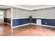 Bright living room with hardwood floors and decorative wallpaper with picture frame molding at 2523 Krueger Lane, Tampa, FL 33618