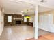 Spacious living room with a stone fireplace, tile floors, and a retro-style bar at 2523 Krueger Lane, Tampa, FL 33618