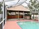 Screened-in pool and patio with an outdoor kitchen creating a relaxing and fun space at 2523 Krueger Lane, Tampa, FL 33618