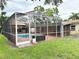 A screened-in outdoor pool area offers a refreshing escape and entertainment space at 2523 Krueger Lane, Tampa, FL 33618