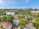 Residential area with mature trees and a view of the city skyline in the distance under a blue sky at 2808 N Highland Ave, Tampa, FL 33602