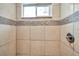 Updated shower stall featuring neutral tile walls, shower head, and window at 2808 N Highland Ave, Tampa, FL 33602