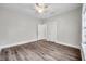 Bedroom featuring dark grey flooring, light grey walls, a ceiling fan, and two doorways at 2808 N Highland Ave, Tampa, FL 33602