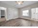 Bedroom featuring dark grey flooring, light grey walls, a ceiling fan, and a view into another room at 2808 N Highland Ave, Tampa, FL 33602