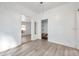 Bright bedroom with white walls, grey wood-look flooring, closet and natural light at 2808 N Highland Ave, Tampa, FL 33602