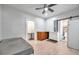 Cozy bedroom with a ceiling fan, convenient bathroom access, and storage with countertop at 2808 N Highland Ave, Tampa, FL 33602