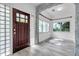 Bright entryway with hardwood front door, accent stone, glass block window and ample natural light at 2808 N Highland Ave, Tampa, FL 33602