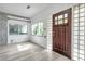 Inviting foyer with natural light, hardwood front door, accent stone and glass block window at 2808 N Highland Ave, Tampa, FL 33602