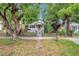 Traditional home with chain link fence and mature trees in the front yard provide natural shade at 2808 N Highland Ave, Tampa, FL 33602