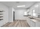 Kitchen featuring a pantry, white cabinets, modern flooring and a double sink at 2808 N Highland Ave, Tampa, FL 33602