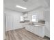 Kitchen features white cabinets, sleek countertops, and modern flooring at 2808 N Highland Ave, Tampa, FL 33602
