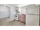 Bright kitchen featuring white appliances, wood flooring, and window bringing in natural light at 2808 N Highland Ave, Tampa, FL 33602