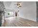 Open living area with stone fireplace, ceiling fan, and hardwood-style flooring at 2808 N Highland Ave, Tampa, FL 33602