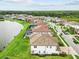 Well-maintained home with tile roof, lush lawn, and community lake access at 28565 Picana Ln, Wesley Chapel, FL 33543
