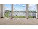 Covered balcony with white columns and black railing offers scenic lake views at 28565 Picana Ln, Wesley Chapel, FL 33543