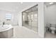 Bright bathroom with soaking tub and glass enclosed shower at 28565 Picana Ln, Wesley Chapel, FL 33543