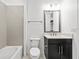 Bathroom featuring a single vanity, tub-shower with tile surround, toilet and neutral color palette at 28565 Picana Ln, Wesley Chapel, FL 33543