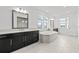 Beautiful bathroom with a large vanity, soaking tub and bright windows offering lots of natural light at 28565 Picana Ln, Wesley Chapel, FL 33543