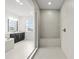 Bright bathroom featuring a glass enclosed shower with a built-in bench at 28565 Picana Ln, Wesley Chapel, FL 33543