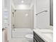Bathroom featuring a single vanity, tub-shower with subway tile surround, toilet and neutral color palette at 28565 Picana Ln, Wesley Chapel, FL 33543