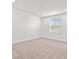 Bright bedroom with plush carpet, white walls, and a window providing natural light at 28565 Picana Ln, Wesley Chapel, FL 33543