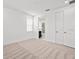 Bright bedroom with plush carpet, neutral walls, and adjacent bathroom, offering a serene and comfortable space at 28565 Picana Ln, Wesley Chapel, FL 33543