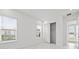 Light and airy bedroom featuring marble flooring, closet space, and natural light at 28565 Picana Ln, Wesley Chapel, FL 33543