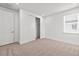 Well-lit bedroom featuring plush carpeting, built-in closet space, and bright window at 28565 Picana Ln, Wesley Chapel, FL 33543