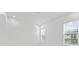 Bright, white bedroom with recessed lights and two large windows at 28565 Picana Ln, Wesley Chapel, FL 33543