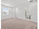 Bedroom features ensuite bathroom, closet, plush carpet and a bright window providing natural light at 28565 Picana Ln, Wesley Chapel, FL 33543