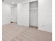 Bedroom with neutral carpet, featuring a closet with sliding doors and closet organizers at 28565 Picana Ln, Wesley Chapel, FL 33543