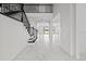 Elegant foyer featuring a staircase, sleek marble floors, and an open view to the living area at 28565 Picana Ln, Wesley Chapel, FL 33543