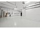 Spacious garage featuring white cabinetry and epoxy flooring providing ample storage and a clean aesthetic at 28565 Picana Ln, Wesley Chapel, FL 33543