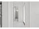 Hallway featuring marble flooring with white walls and doors at 28565 Picana Ln, Wesley Chapel, FL 33543
