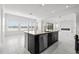 Open concept kitchen island featuring modern fixtures, stainless steel appliances and tile flooring at 28565 Picana Ln, Wesley Chapel, FL 33543
