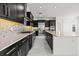 Elegant kitchen featuring a spacious island, stainless steel appliances and modern cabinetry at 28565 Picana Ln, Wesley Chapel, FL 33543
