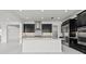Stylish kitchen featuring a center island, mosaic backsplash, stainless steel appliances and dark cabinets at 28565 Picana Ln, Wesley Chapel, FL 33543