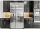 Close up of the kitchen's stainless steel fridge and ovens against dark wood cabinets and countertops at 28565 Picana Ln, Wesley Chapel, FL 33543