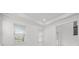 Bright living room featuring large windows with white trim and elegant crown molding at 28565 Picana Ln, Wesley Chapel, FL 33543