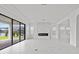 Bright living space with a modern fireplace, tile flooring, and glass sliding doors at 28565 Picana Ln, Wesley Chapel, FL 33543